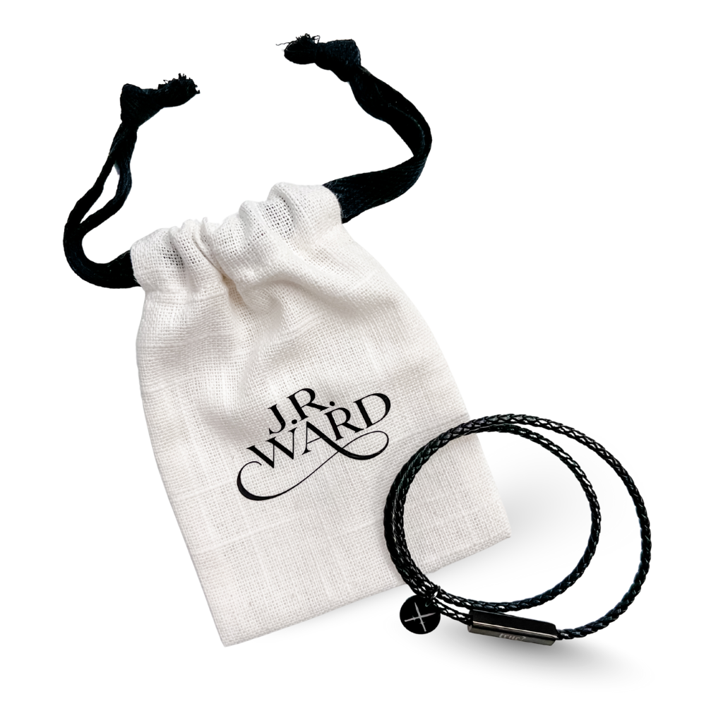 Black braided bracelet on a white drawstring bag with 'J.R. Ward' branding.