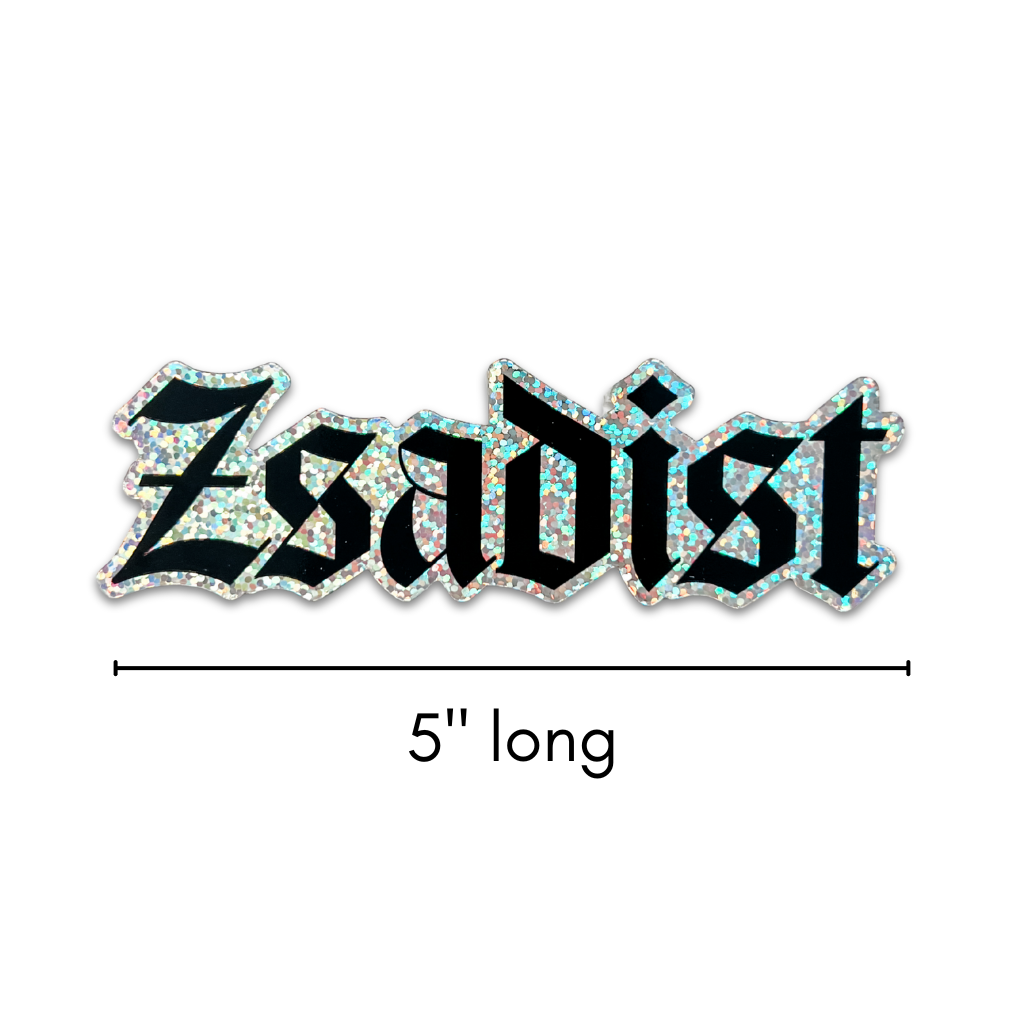a glitter sticker with "Zsadist" in black gothic text