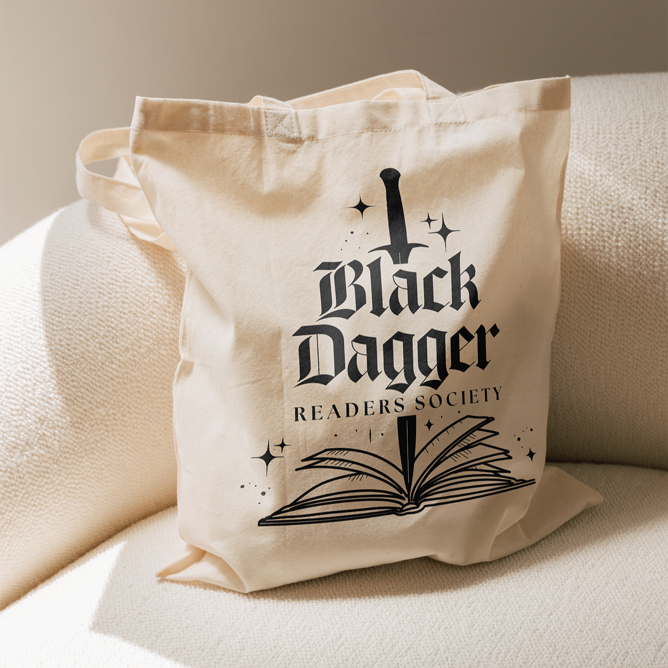 Beige tote bag with 'Black Dagger Readers Society' design on a beige surface
