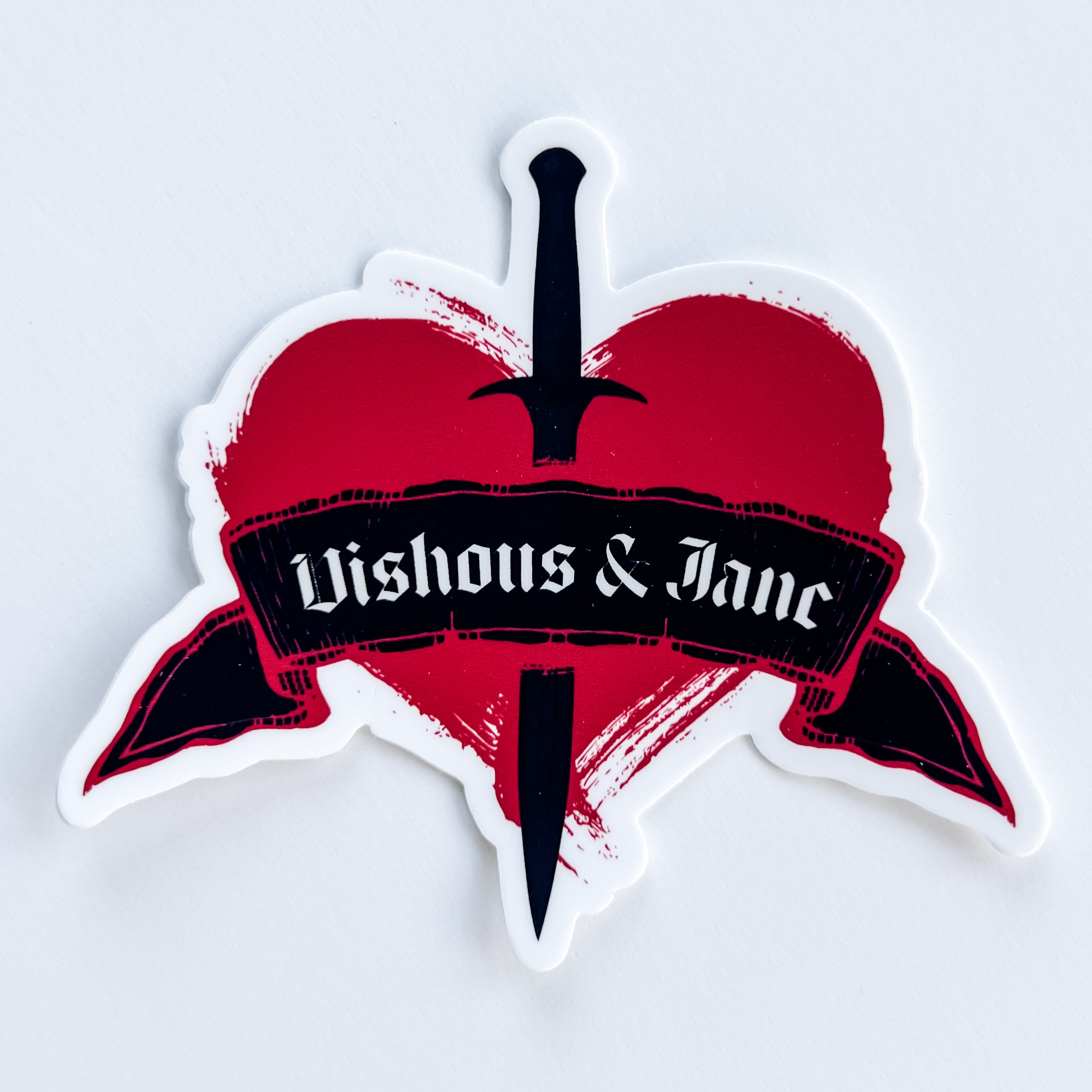 Sticker with a red heart, black ribbon, and 'Vishous & Jane' text on a white background