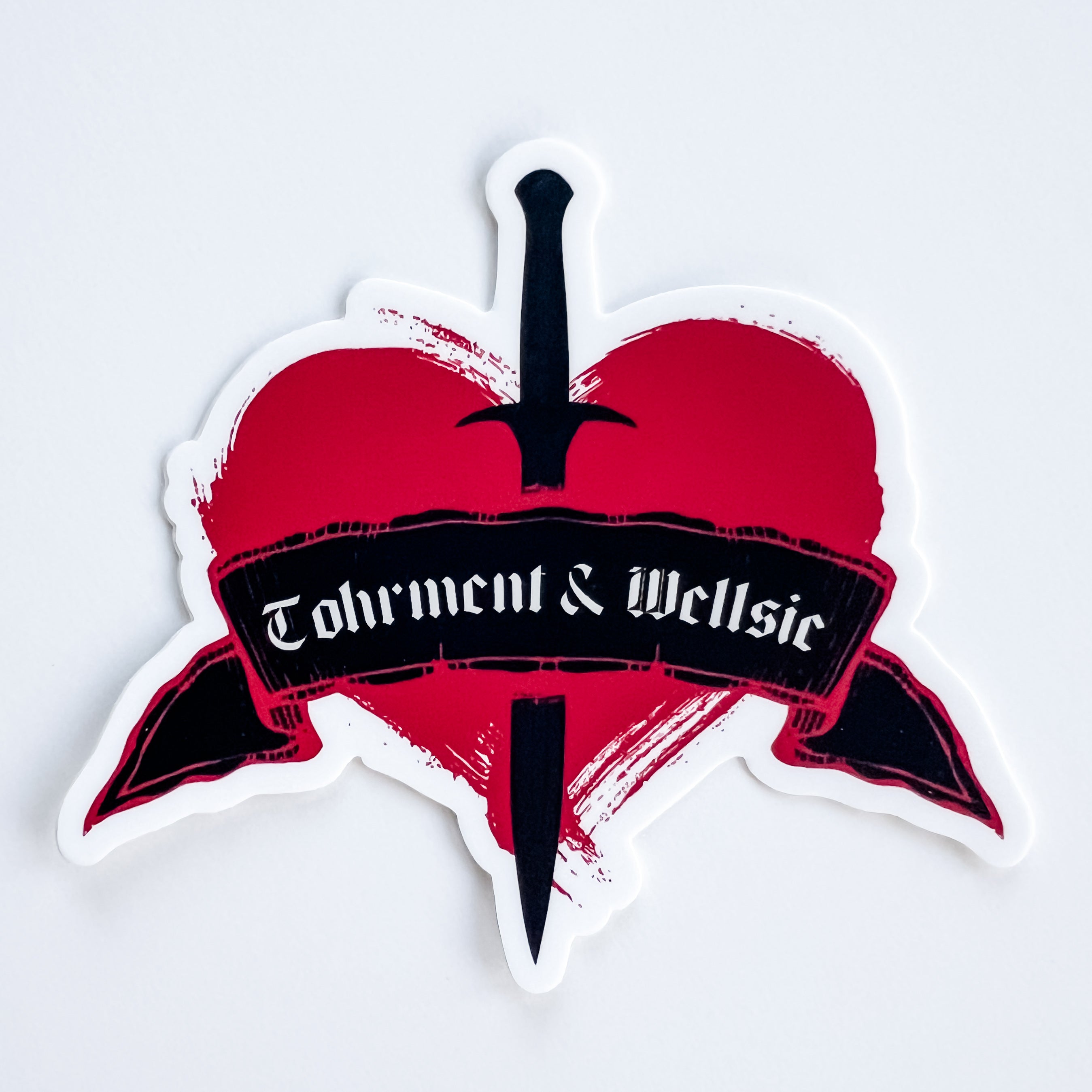 heart shapes sticker with "Tohrment & Wellsie"
