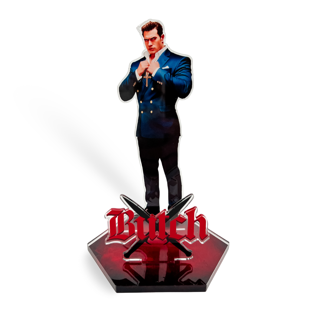 An acrylic standee of Butch in blue suit with a gold cross. Crossed swords on a red platform, featuring the word 'Butch' in red text.