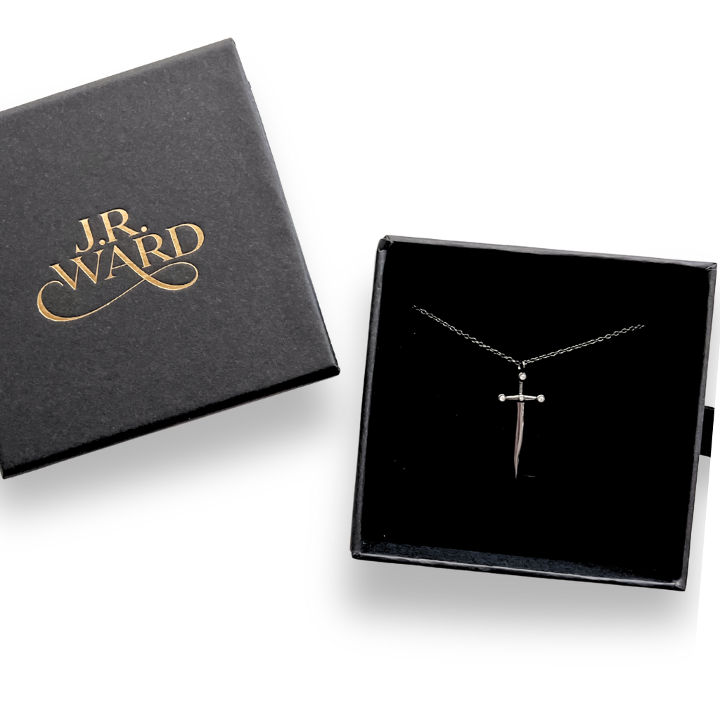 J.R. Ward jewelry box with a necklace featuring a dagger pendant on a white background