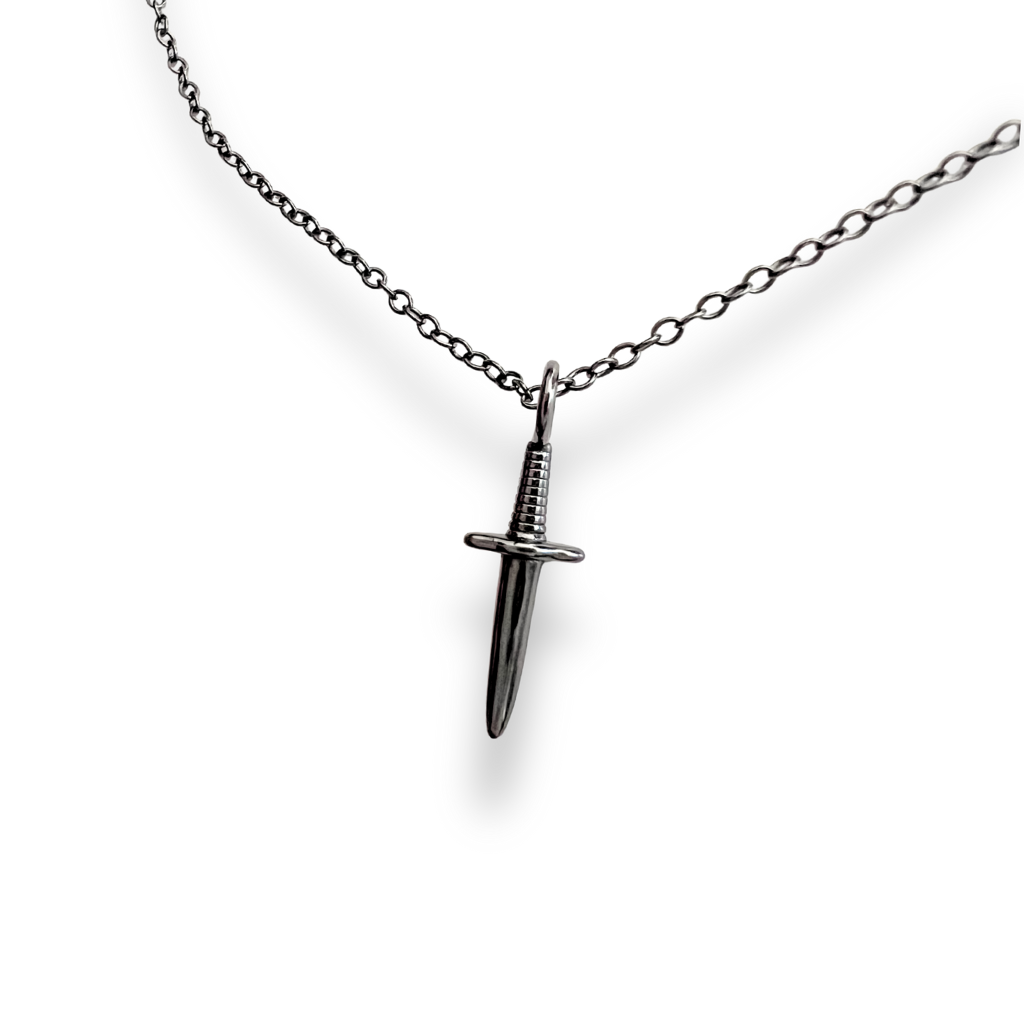 Black dagger pendant necklace on a white background