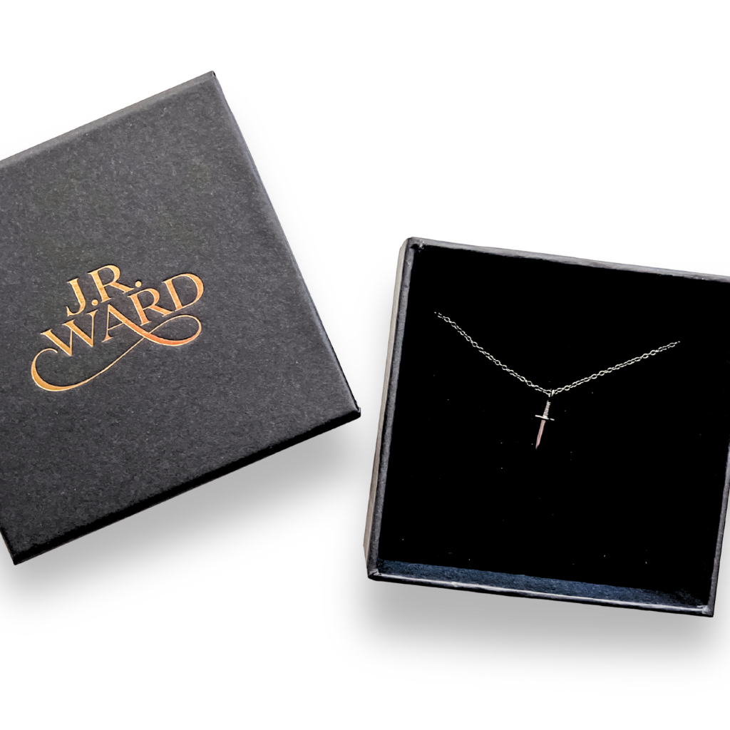 J.R. Ward jewelry box with a black dagger necklace on a white background