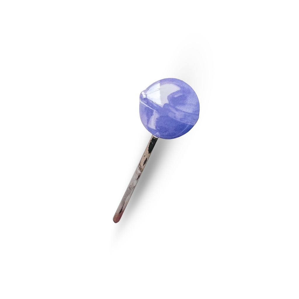 A purple tootsie pop inspired pin on a white background