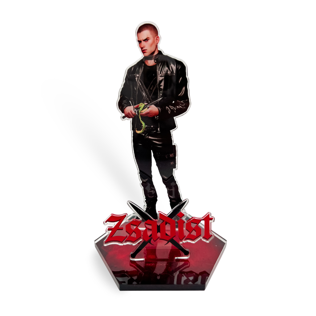Figurine of Zsadist in a leather jacket peeling a green apple. 'Zsadist' in red letters sits over black crossed daggers. 