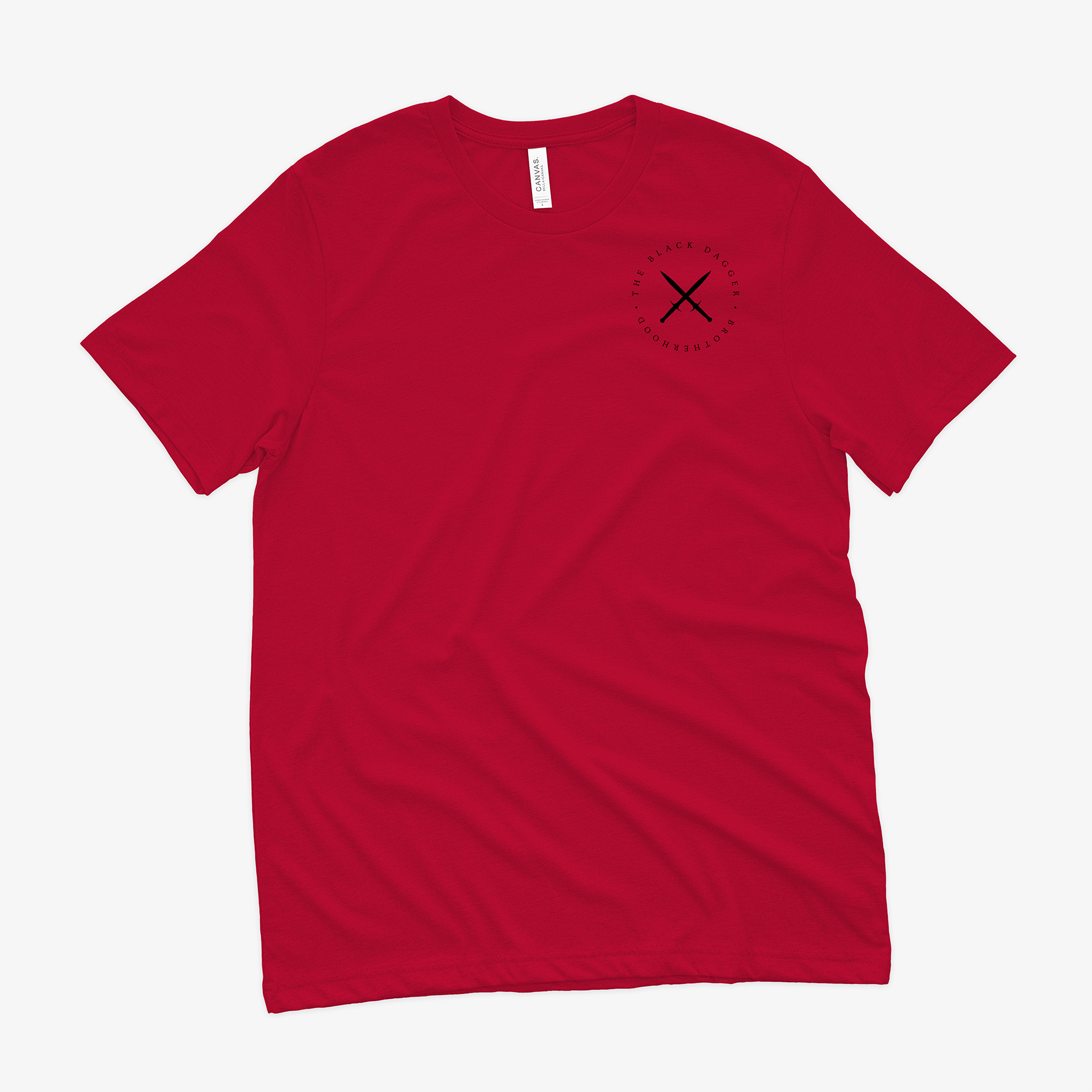 the front of a red shirt with an emblem on the top left shoulder. It's a circle with crossed black daggers and the words "Black Dagger Brotherhood" encircling it.