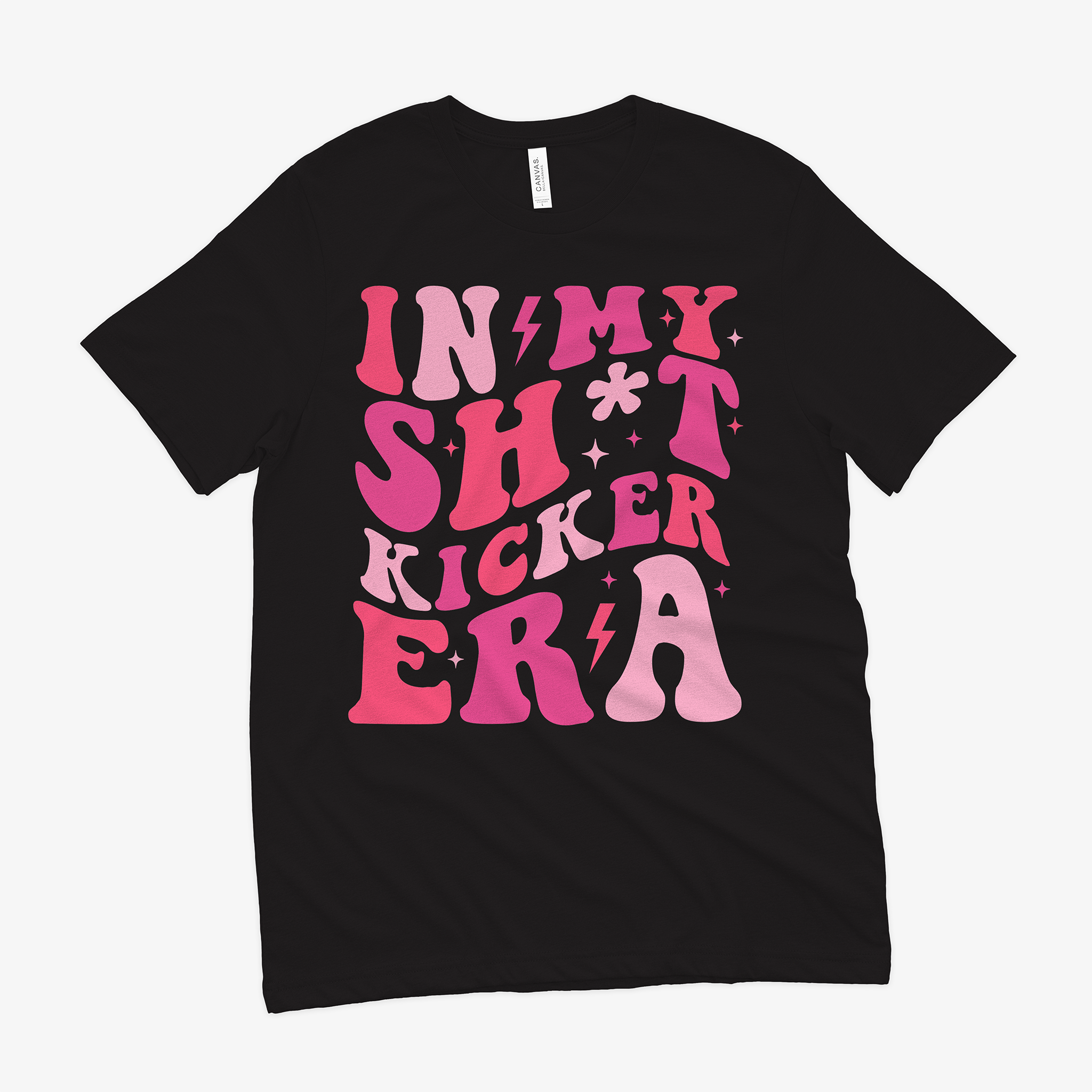 a black shirt with the words "In my sh*t kicker era" emblazoned on the front in fun pink tones in a retro font