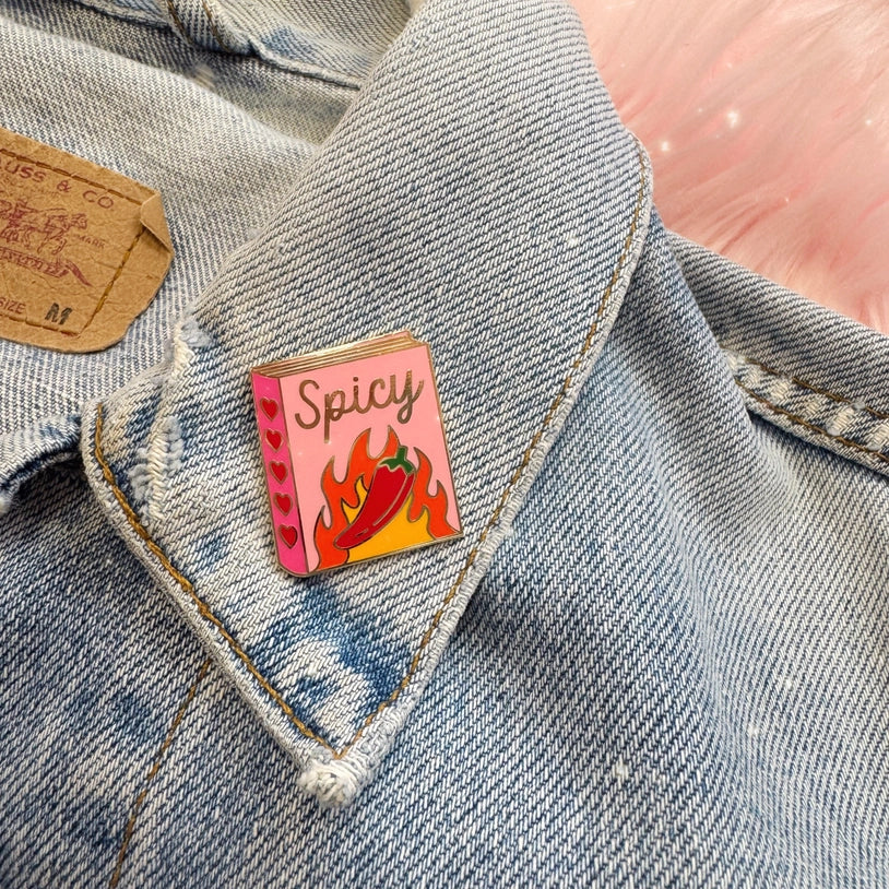 Spicy-themed enamel pin on a denim jacket