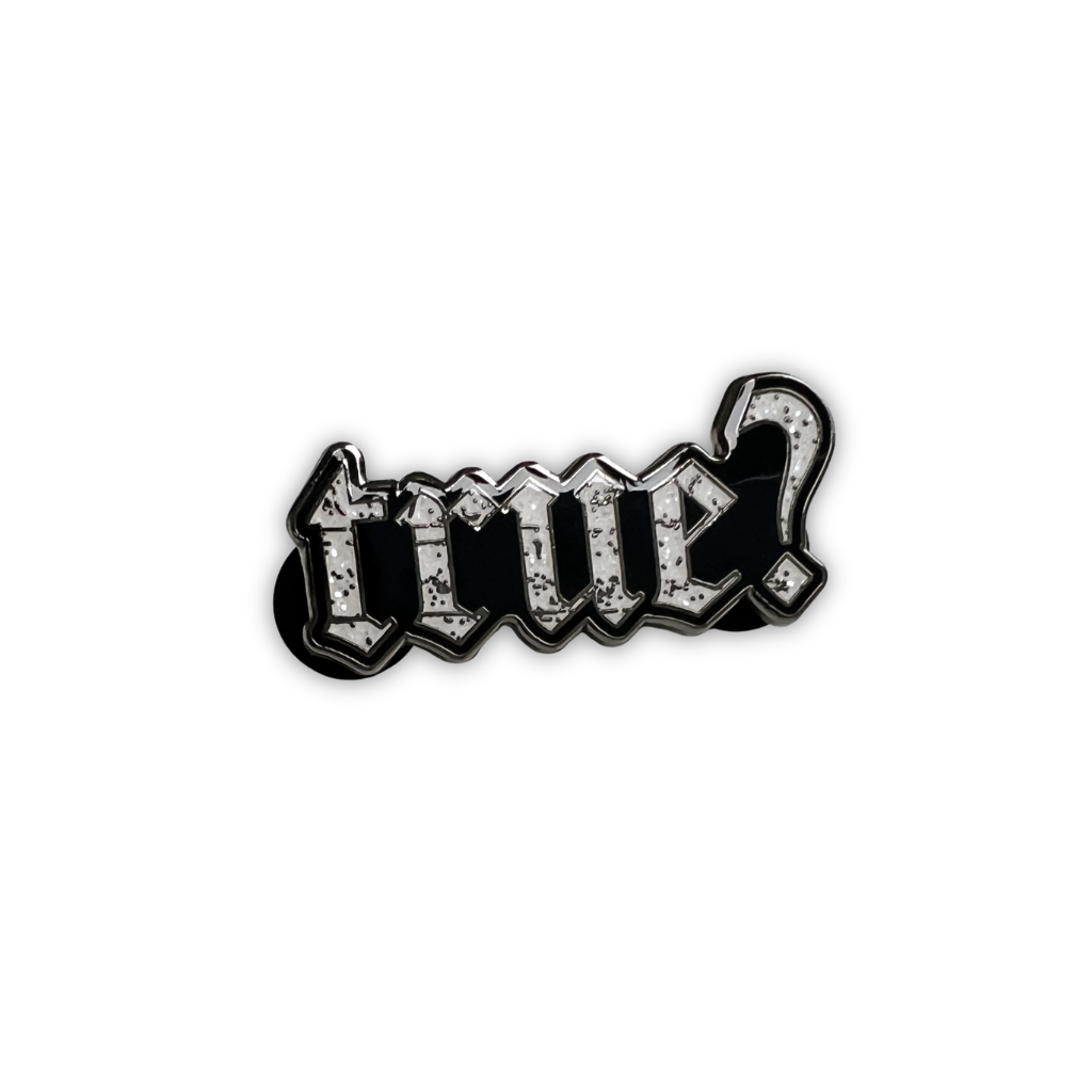 A gothic-style enamel pin spelling 'true?' with a question mark, featuring a distressed silver and black design on a plain white background.